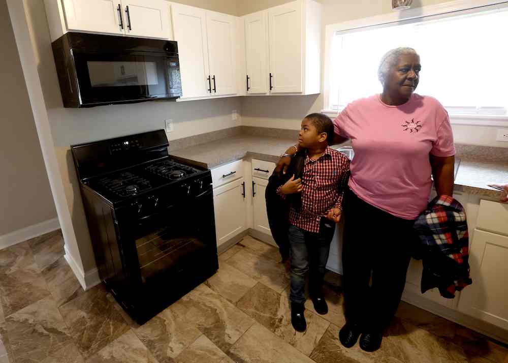 Cynthia Whitaker shows her new home to grandson