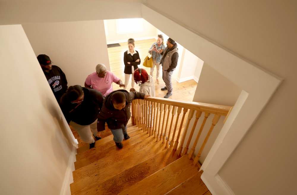 Cynthia Whitaker tours her new house on South Salina Street with her family and staff from Home HeadQuarters